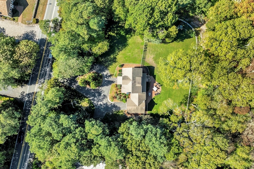 665 Route 6A Sandwich, MA 02537 - Photo 4 of 42 an aerial view of a house with a yard