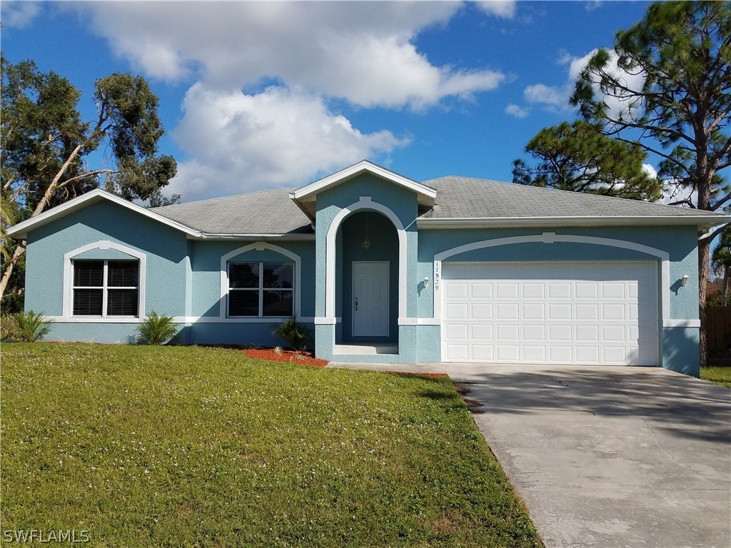 17529 Butler Road Fort Myers, FL 33967 - Photo 1 of 15 a view of a house with a yard and garage