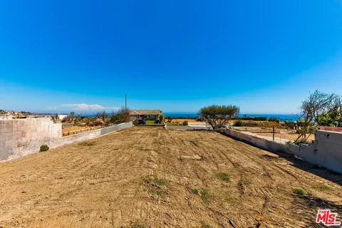 an aerial view of residential building and ocean
