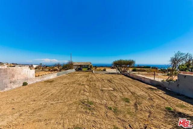 an aerial view of residential building and ocean