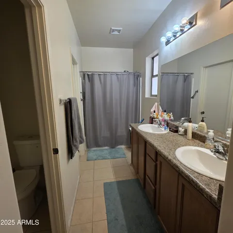 a bathroom with a double vanity sink and a mirror