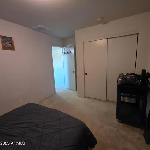 a bedroom with a bed and a dresser