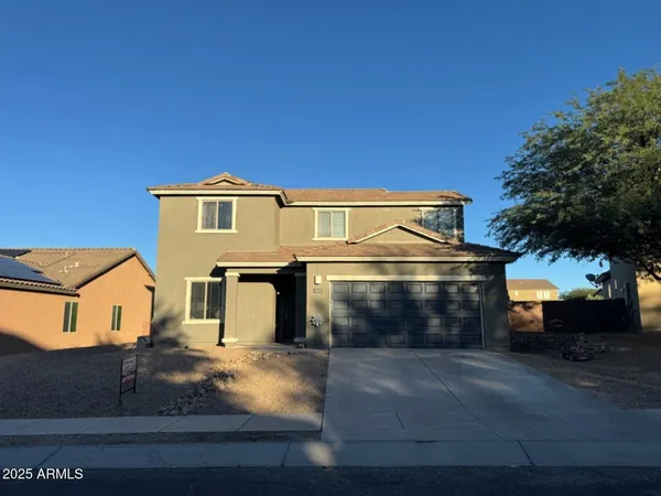 a front view of a house with yard
