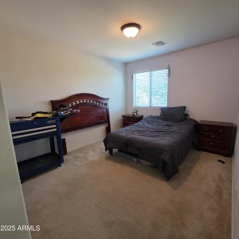 a bedroom with a bed and a window