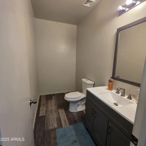 a bathroom with a sink toilet and a mirror