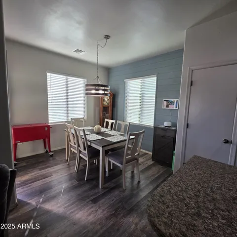 a view of a dining room with furniture and window
