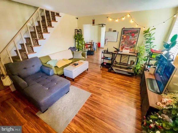 a living room with furniture rug and wooden floor