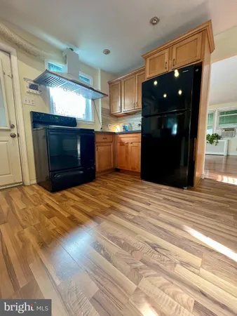 a kitchen with a refrigerator and a sink