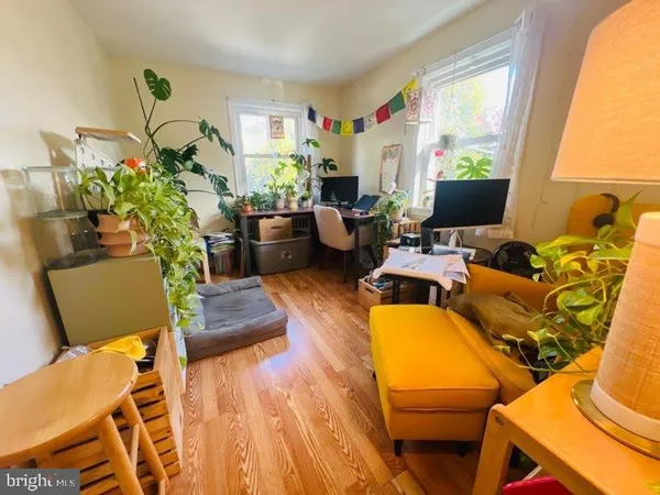 a living room with furniture fireplace and a large window