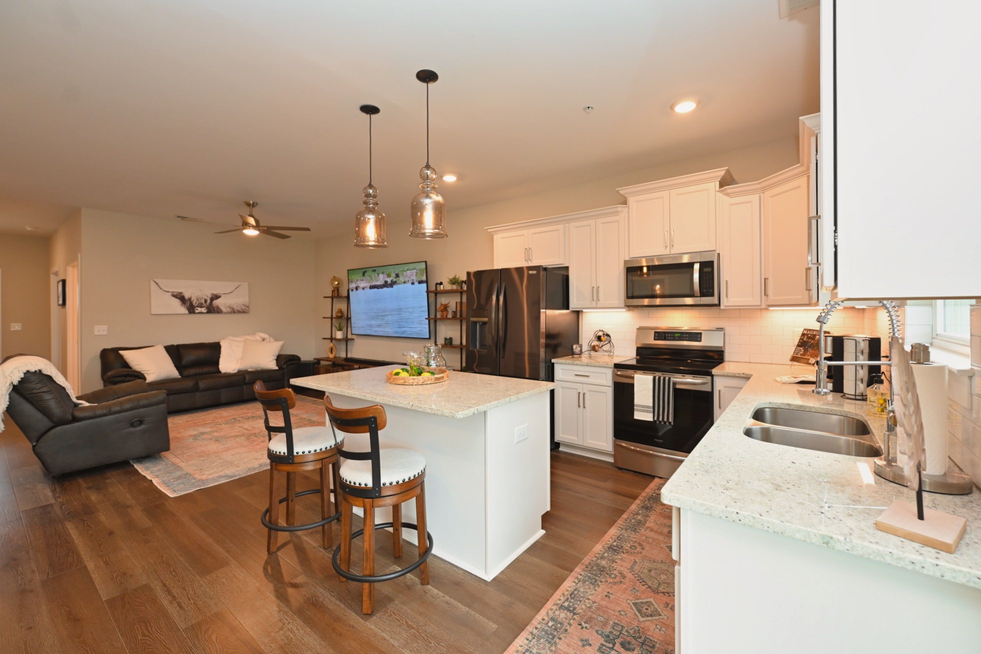 1144 Lock 4 Road, Unit J4 Gallatin, TN 37066 - Photo 12 of 39 a living room with stainless steel appliances furniture a rug kitchen view and a chandelier