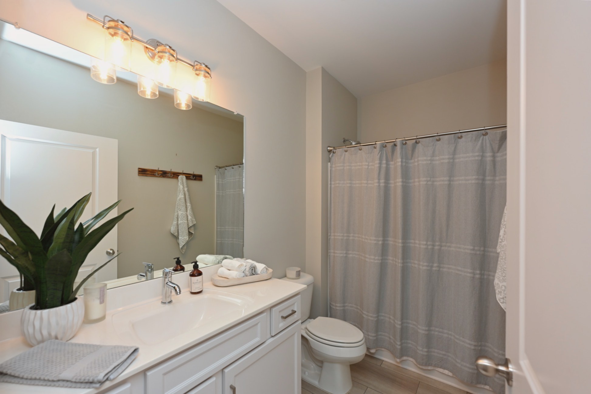 1144 Lock 4 Road, Unit J4 Gallatin, TN 37066 - Photo 26 of 39 a bathroom with a sink a mirror and a toilet