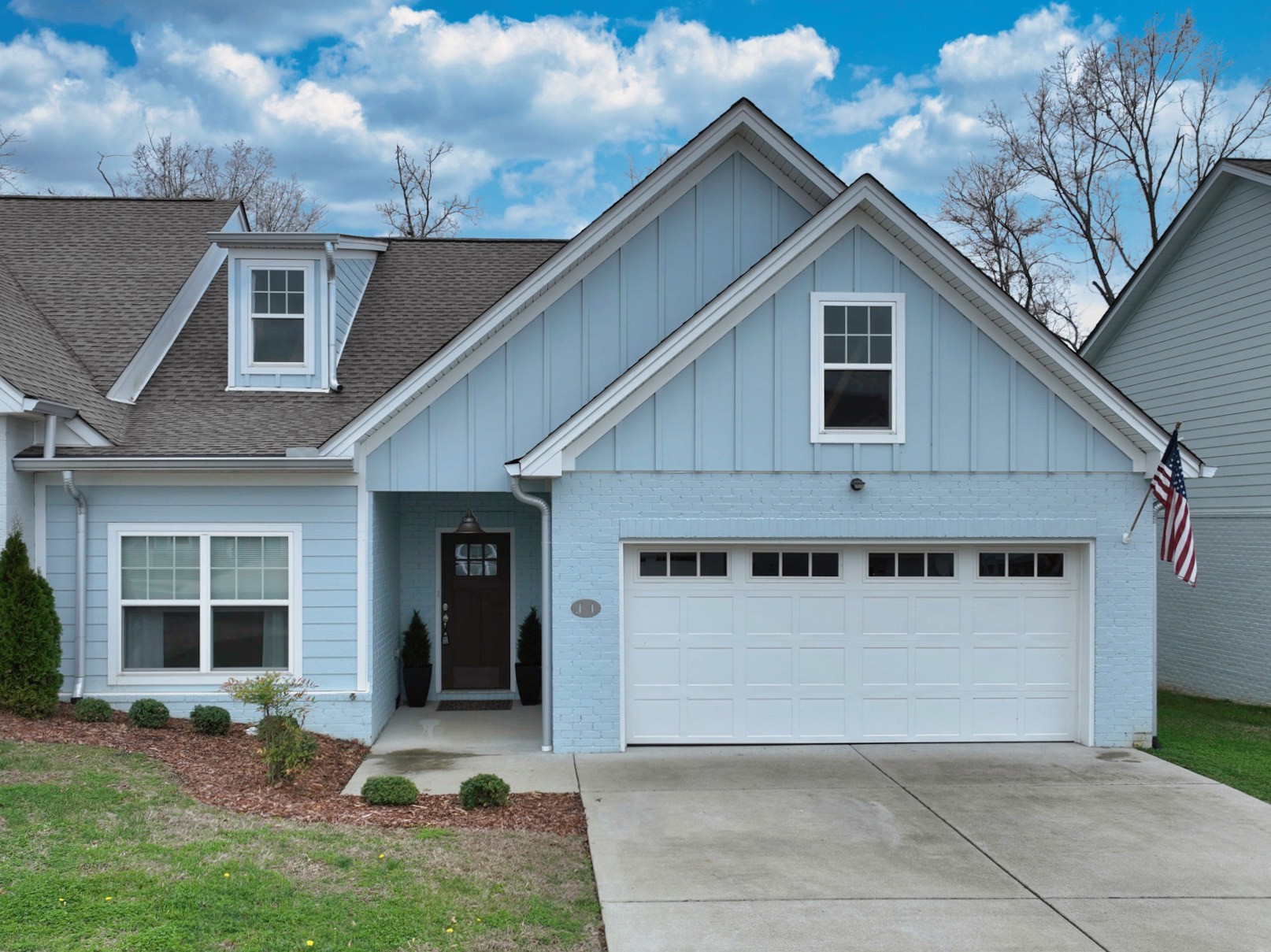 1144 Lock 4 Road, Unit J4 Gallatin, TN 37066 - Photo 3 of 39 a front view of a house with a yard and garage