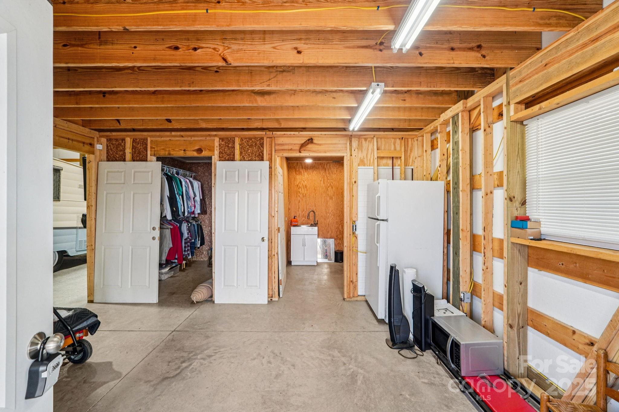 510 Lillys Bridge Road Mount Gilead, NC 27306 - Photo 13 of 18 a view of walk in closet with clothes and shoes