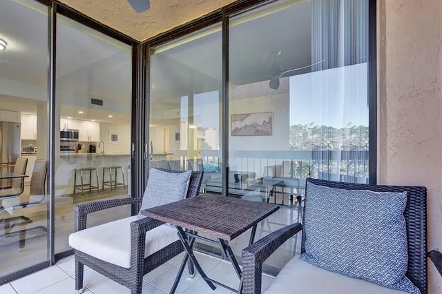 a living room with a table chairs and wooden floor
