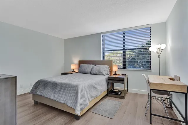 a bed sitting in a bedroom next to a window