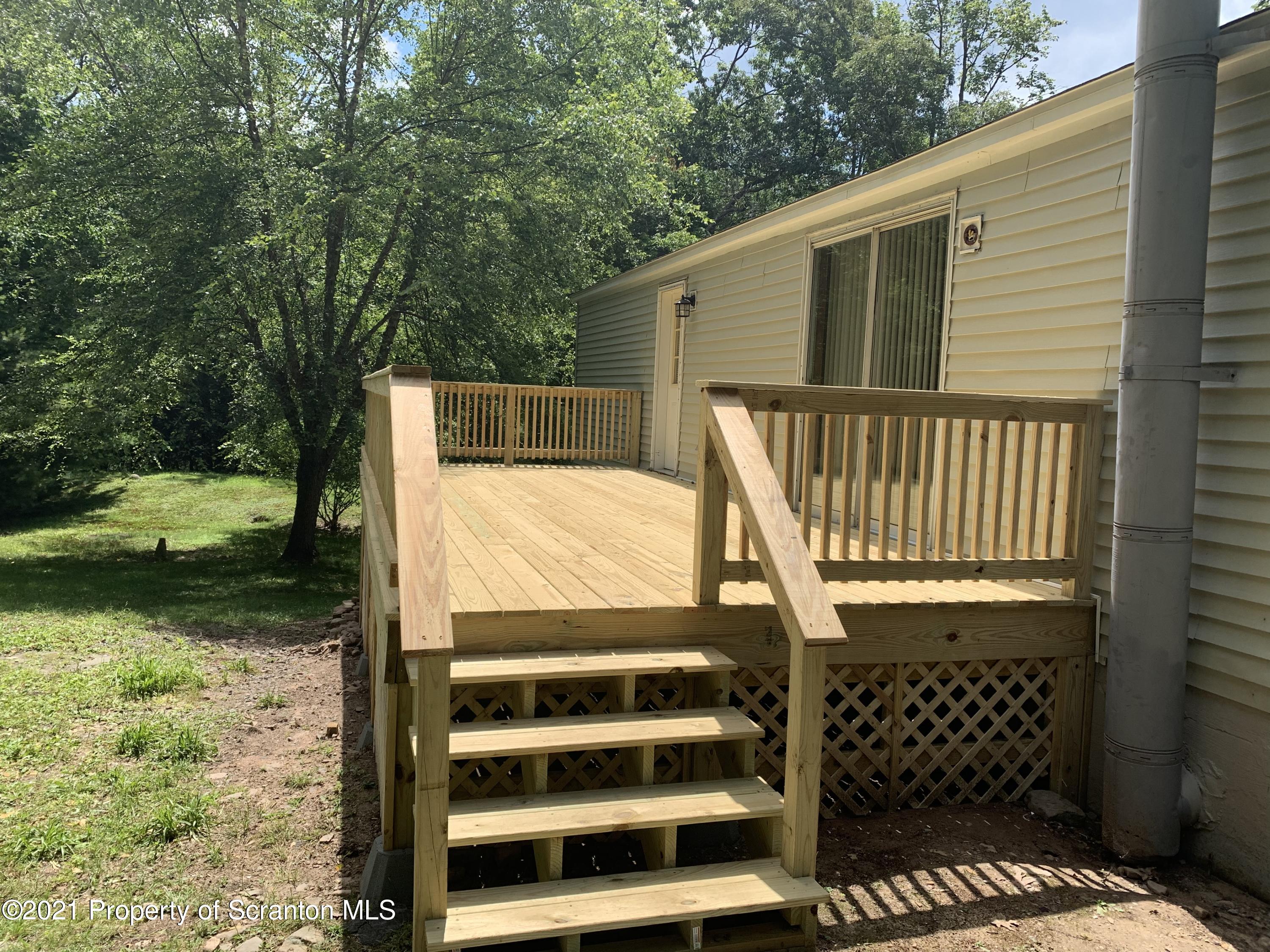 2060 Moosic Lakes Road Lake Ariel, PA 18436 - Photo 6 of 44 a view of a balcony with wooden floor and fence