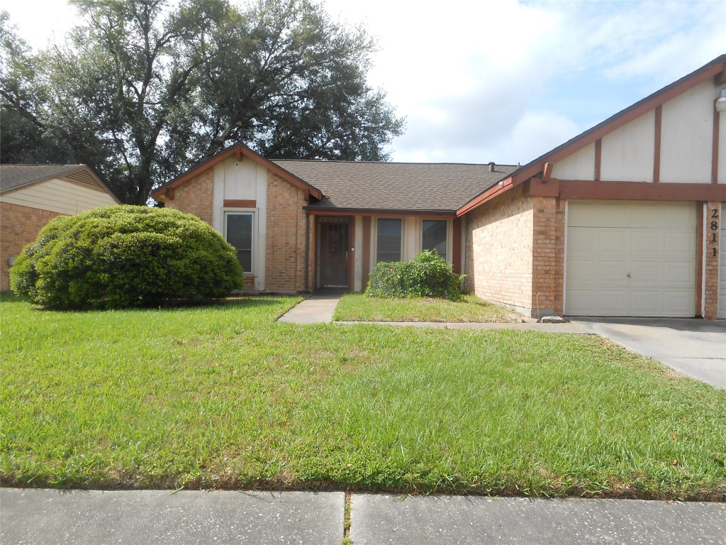 2811 Ashington Drive Houston, TX 77067 - Photo 2 of 9 a front view of house with yard and garage