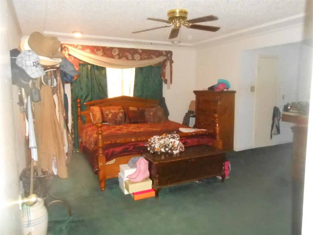 2811 Ashington Drive Houston, TX 77067 - Photo 7 of 9 a bedroom with furniture and a chandelier
