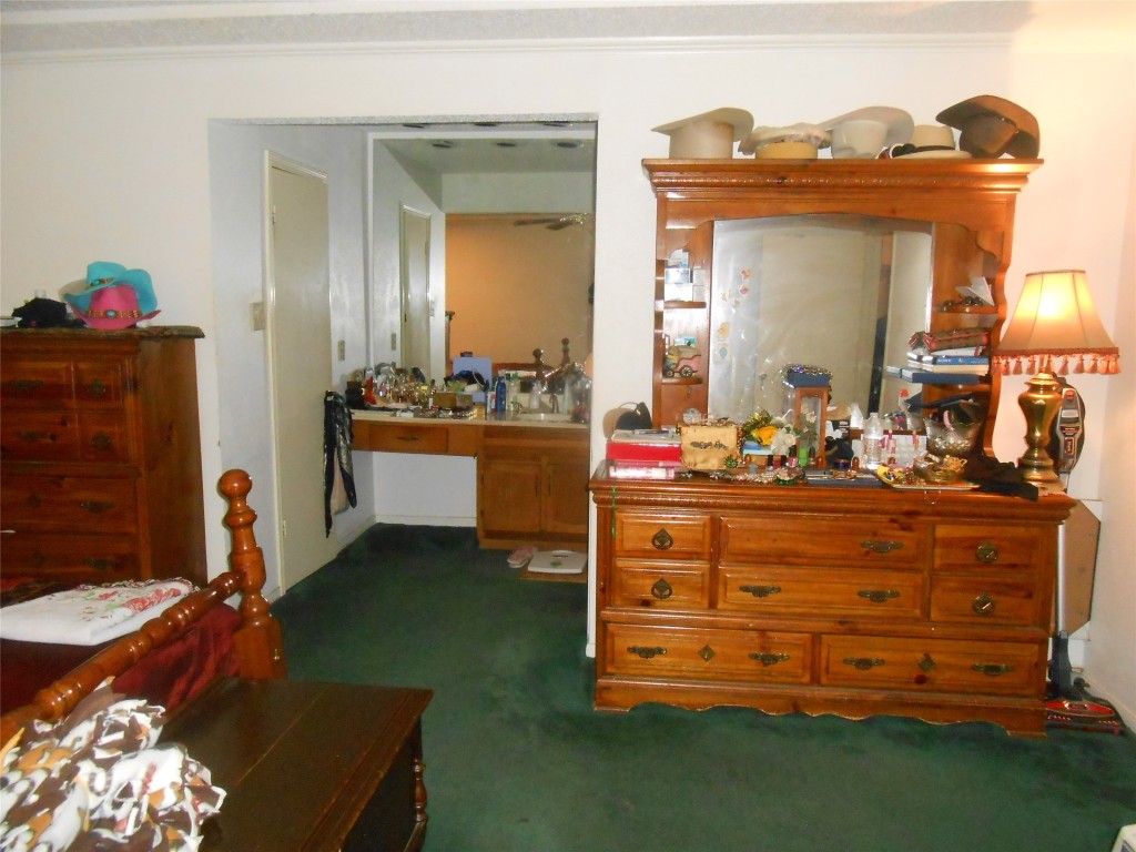 2811 Ashington Drive Houston, TX 77067 - Photo 8 of 9 a room with a bed and a mirror on dresser