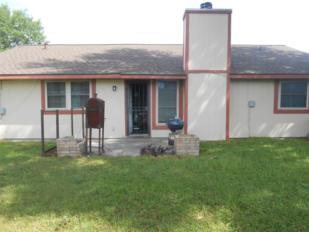 2811 Ashington Drive Houston, TX 77067 - Photo 9 of 9 a front view of a house with a garden and plants