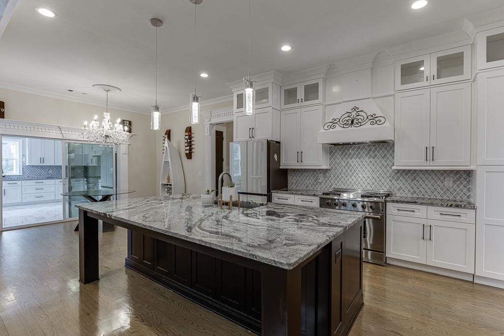 861 Bailey Woods Road Dacula, GA 30019 - Photo 15 of 67 a kitchen with stainless steel appliances granite countertop a stove a sink and a refrigerator