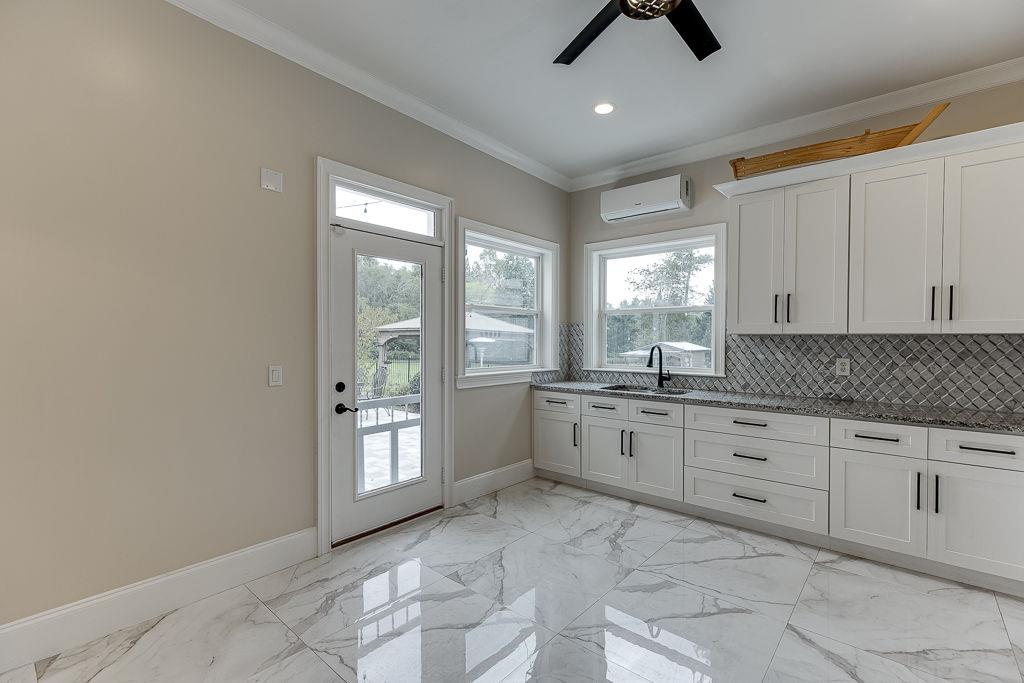 861 Bailey Woods Road Dacula, GA 30019 - Photo 22 of 67 a large white kitchen with a window