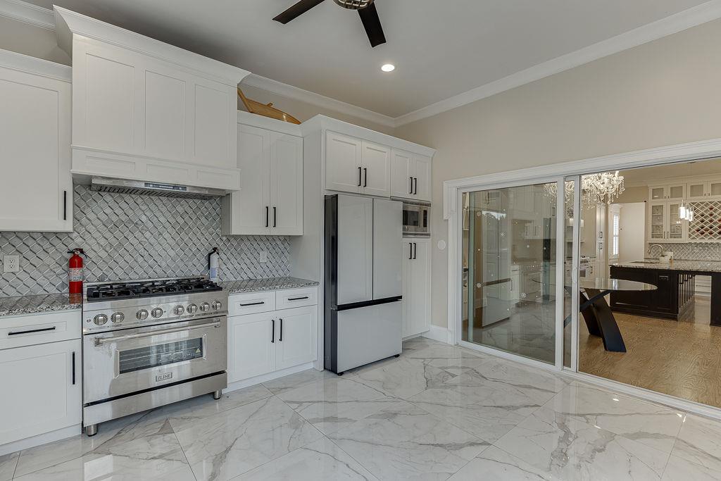 861 Bailey Woods Road Dacula, GA 30019 - Photo 23 of 67 a kitchen with white cabinets and stainless steel appliances