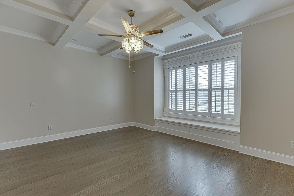 861 Bailey Woods Road Dacula, GA 30019 - Photo 24 of 67 an empty room with wooden floor fan and windows