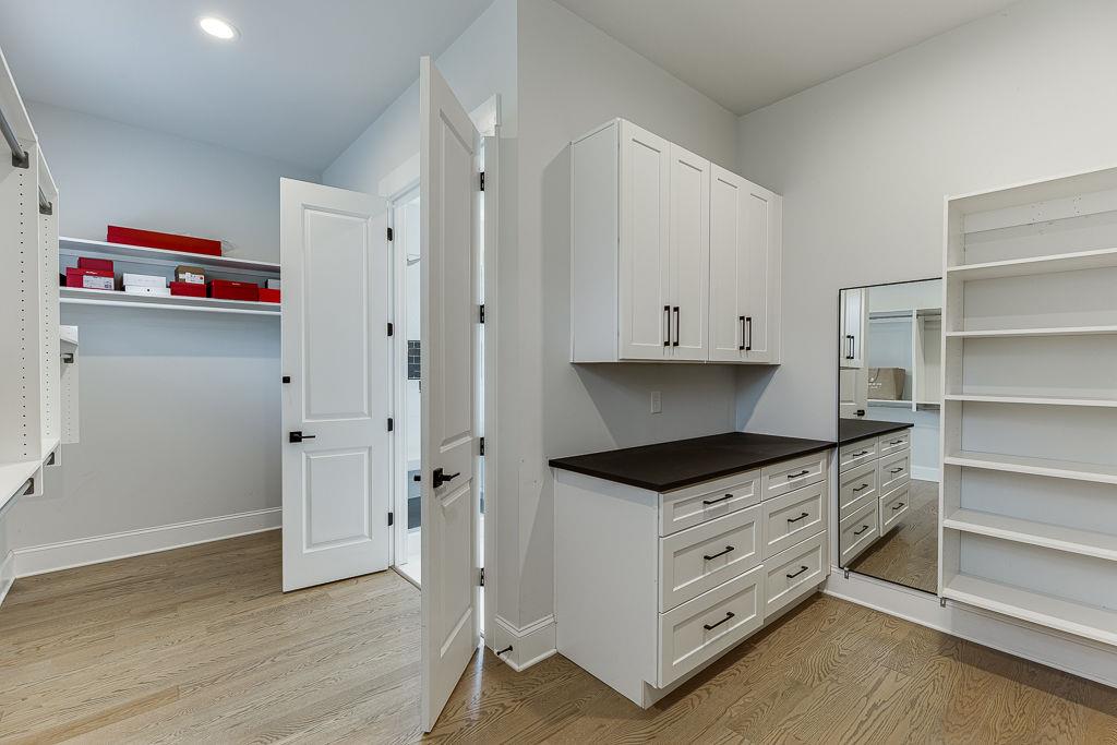 861 Bailey Woods Road Dacula, GA 30019 - Photo 30 of 67 a kitchen with granite countertop a white stove and cabinets