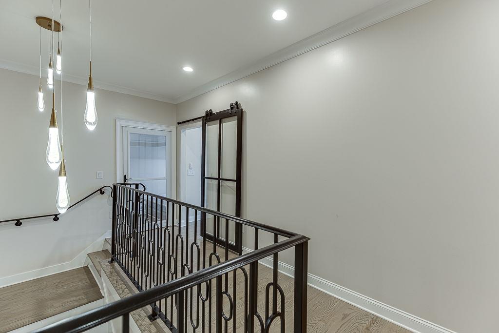 861 Bailey Woods Road Dacula, GA 30019 - Photo 33 of 67 a view of staircase with railing and a chandelier