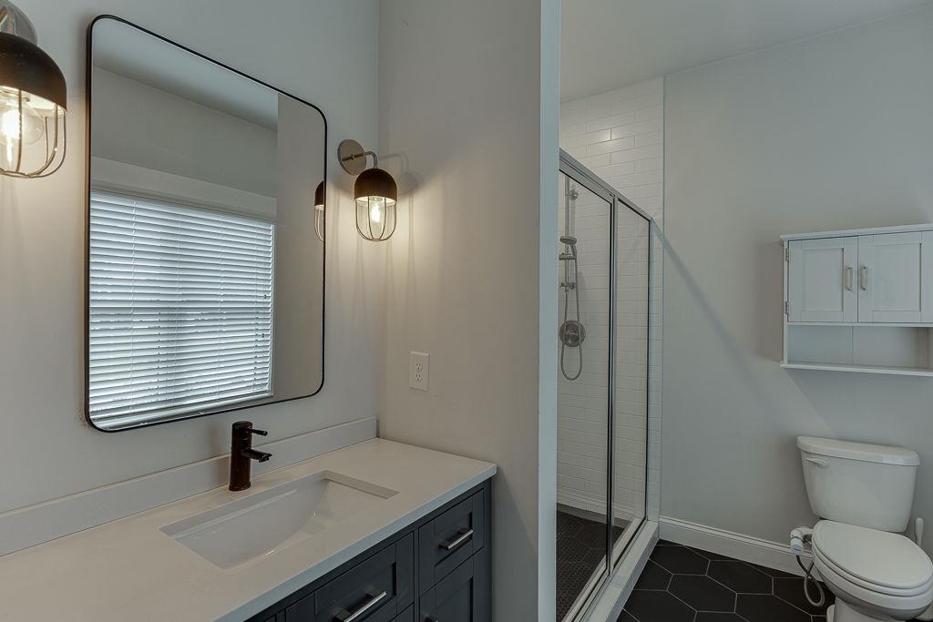 861 Bailey Woods Road Dacula, GA 30019 - Photo 40 of 67 a bathroom with a sink a toilet and shower