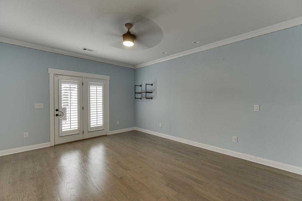 861 Bailey Woods Road Dacula, GA 30019 - Photo 44 of 67 an empty room with wooden floor and windows
