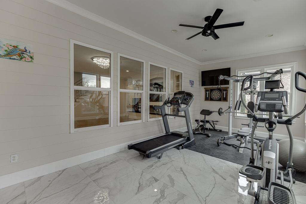 861 Bailey Woods Road Dacula, GA 30019 - Photo 48 of 67 a room with gym equipment and windows