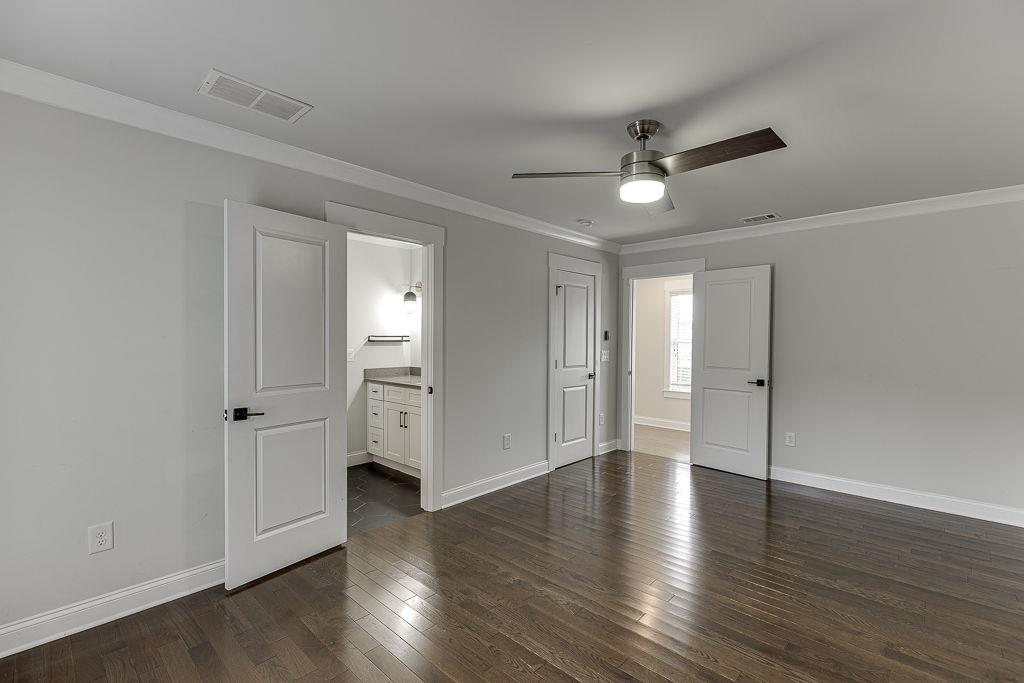 861 Bailey Woods Road Dacula, GA 30019 - Photo 50 of 67 an empty room with wooden floor cabinet and windows