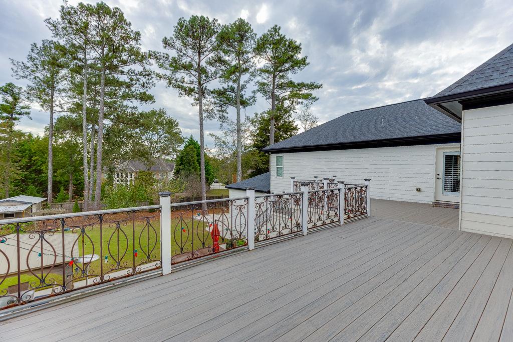 861 Bailey Woods Road Dacula, GA 30019 - Photo 56 of 67 a view of a deck with wooden floor and fence next to a yard