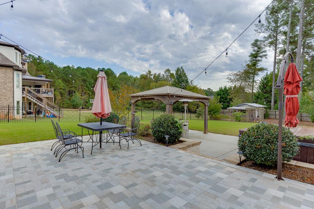 861 Bailey Woods Road Dacula, GA 30019 - Photo 57 of 67 a view of a table and chairs under an umbrella