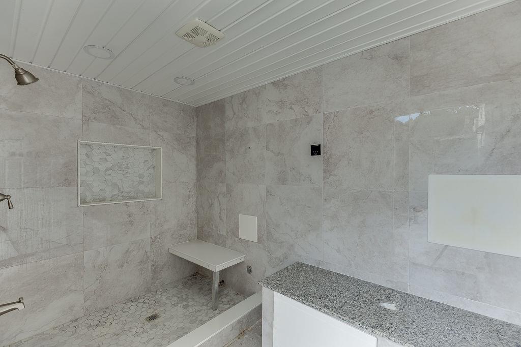 861 Bailey Woods Road Dacula, GA 30019 - Photo 59 of 67 a bathroom with a granite countertop shower a sink and a toilet