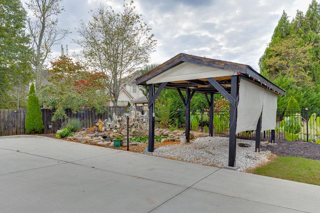 861 Bailey Woods Road Dacula, GA 30019 - Photo 63 of 67 a wooden bench sitting in front of a house