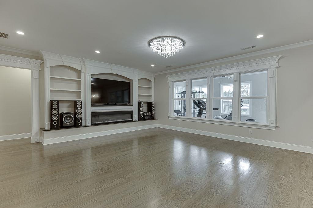 861 Bailey Woods Road Dacula, GA 30019 - Photo 10 of 67 a view of a livingroom with a furniture wooden floor and a fireplace