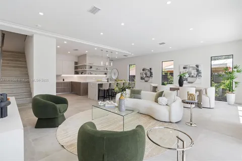 a living room with furniture and view of kitchen
