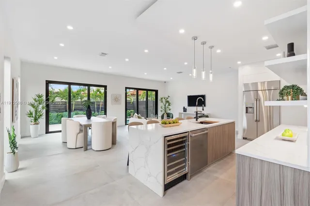 a large white kitchen with a large window