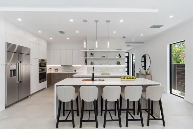 a large kitchen with a table and chairs