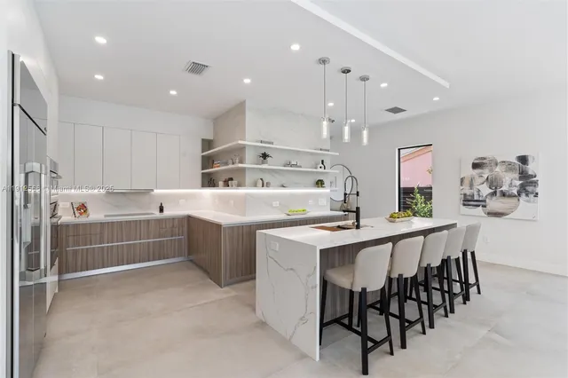 a kitchen with a table chairs sink and cabinets
