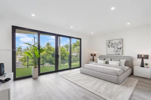 a bedroom with a large bed and a painting on the wall