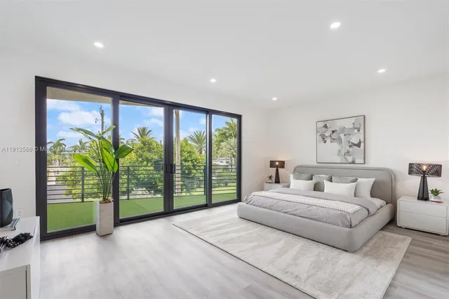 a bedroom with a large bed and a painting on the wall