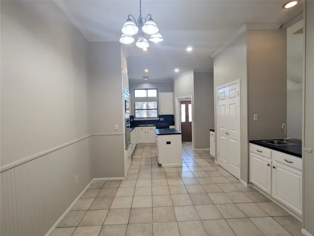 a large white kitchen with a stove a sink and dishwasher