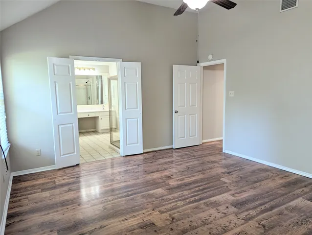 a view of empty room with wooden floor