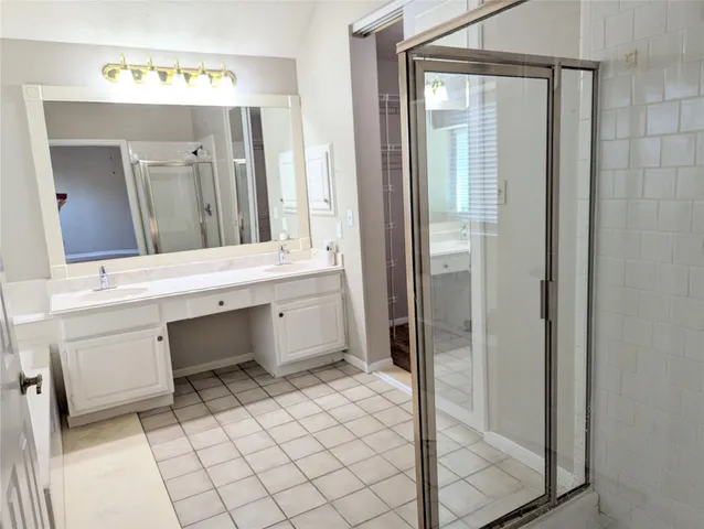 a bathroom with a sink a mirror and a shower