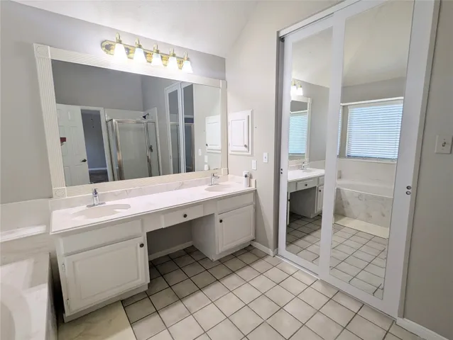 a spacious bathroom with a granite countertop sink mirror and