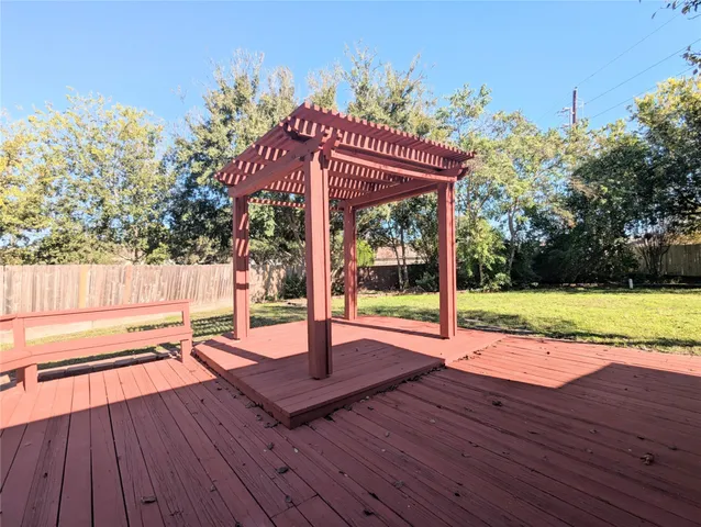 a view of a house with wooden floor and yard